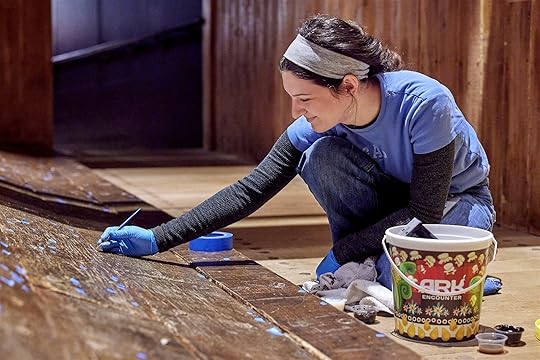 Artist painting some Ark planks at the Creation Museum