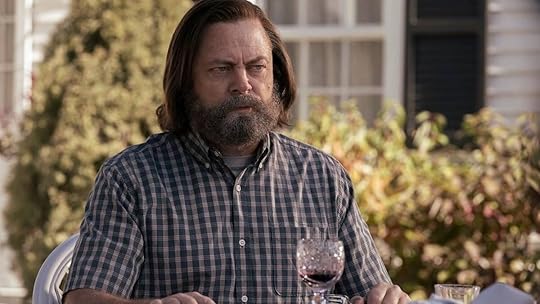 Bill sits uneasy while eating dinne routside on The Last of Us