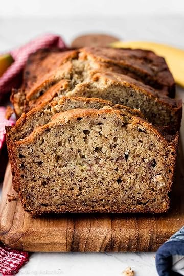 homemade banana bread slices on wooden cutting board.