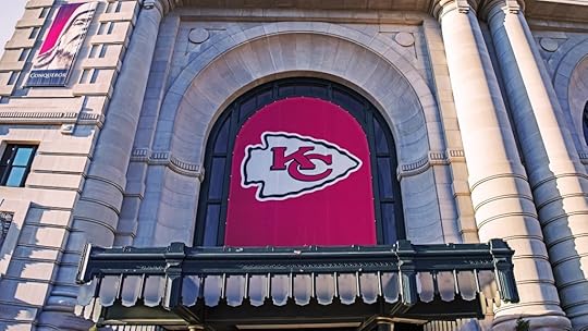 image shows the Kansas City Chiefs logo in a large arched window of a stone building