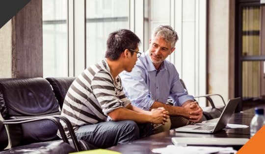 two co-workers seated at a desk discussing how to build a network of resilience