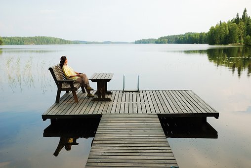 woman on a chair by a lake