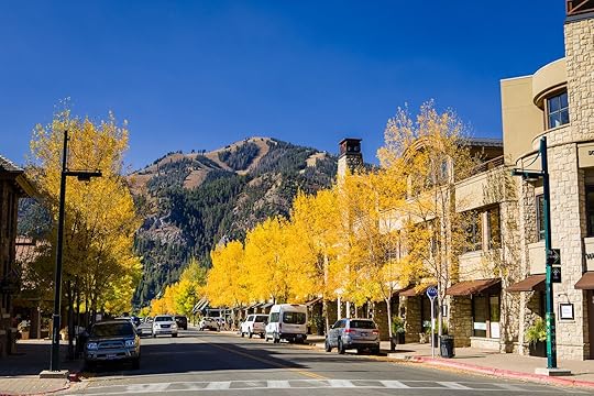 Downtown Sun Valley Idaho on a fall day with leaves turning yellow on the trees and cars parked on the street