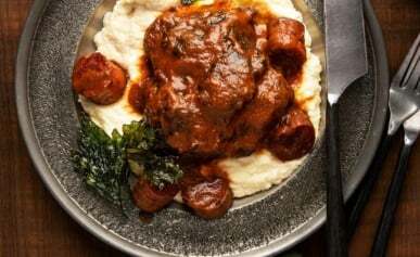 Red wine braised beef cheeks over mashed potatoes.