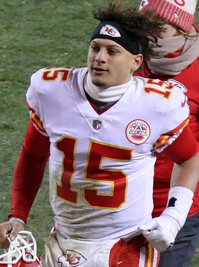 Photo of Patrick Mahomes jogging across the football field in white uniform