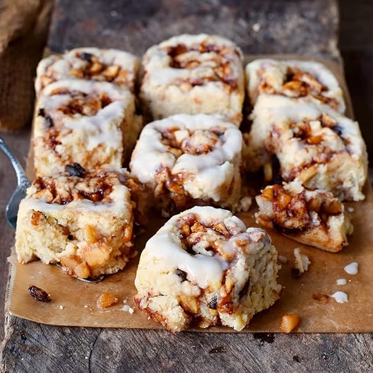 9 vegan cinnamon rolls with apple on parchment paper