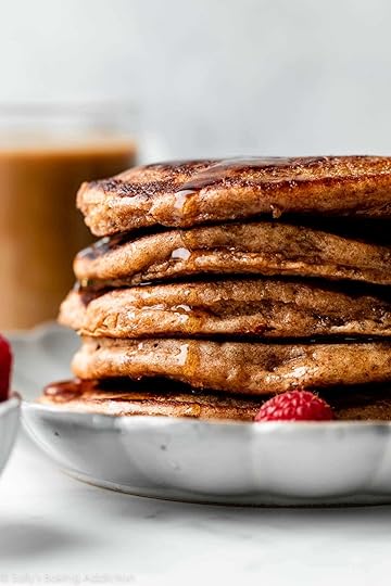 stack of whole wheat pancakes with maple syrup dripping down.