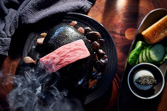 wagyu steak cooking on river rock