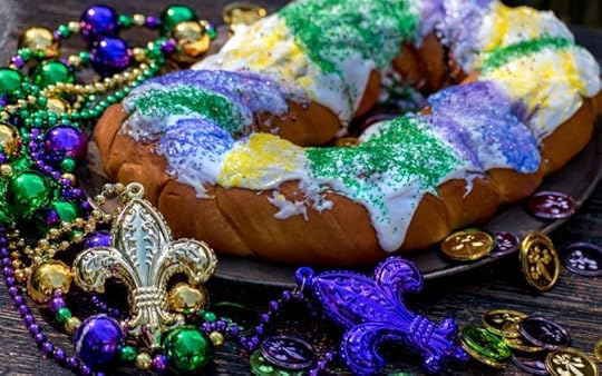 Image of a King cake with green, gold, and purple sprinkles.