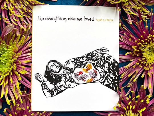 A copy of the micro chapbook like everything else we loved by Sarah A. Chavez framed by flowers.