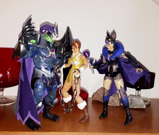 Skelegod harasses the captured Teela, while Evil-Lyn looks on.