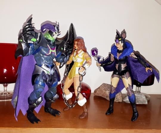 Skelegod harasses Teela, while Evil-Lyn looks on.