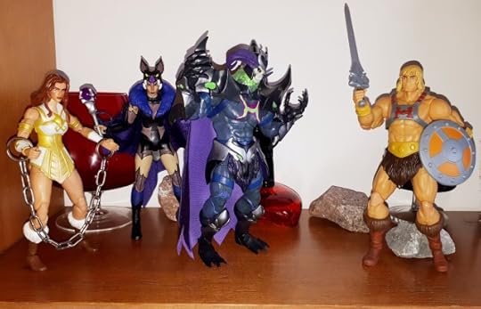 He-Man confronts Skelegod, while Evil-Lyn and the chained up Teela look on.