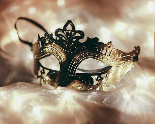 Strange Request - shows a copper-colored mask on a bed of twinkling lights that are covered with a transparent material.