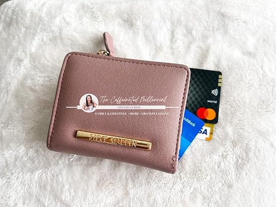 Tips for saving money image: A bliss pink purse laying on top of three credit cards. The bloggers logo- The Caffeinated Millennial: Shandean Reid on on the purse.