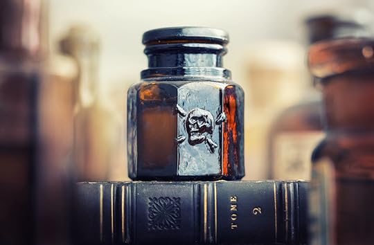 Glass poison bottle with skull and bones