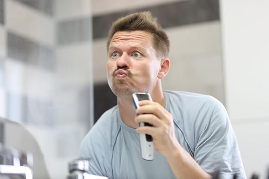 freelancer looking in the bathroom mirror