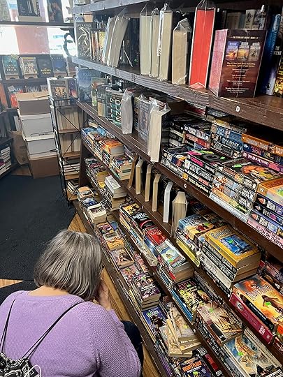 Sharon Browsing used books at Artifact Bookstore, Encinitas, CA