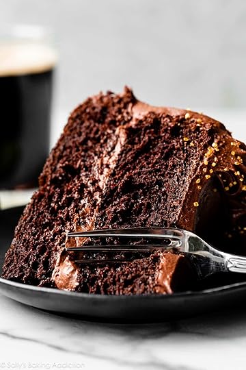 slice of Guinness chocolate cake on black plate with fork going through it.