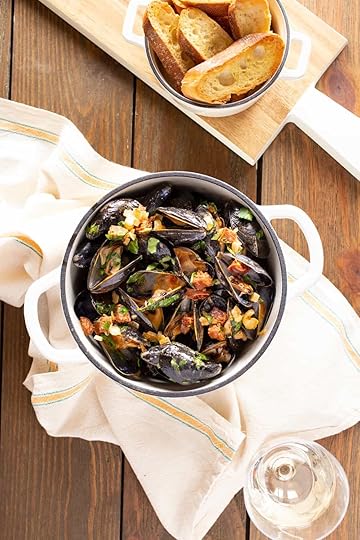 Dutch oven filled with mussels steamed with Spanish chorizo and wine