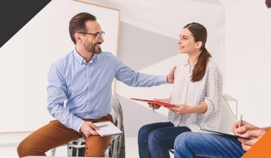 two employees seated next to each other discussion strategies to practice gratitude