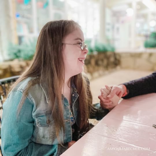 photo of Penny smiling off camera at her dad who is holding her hand