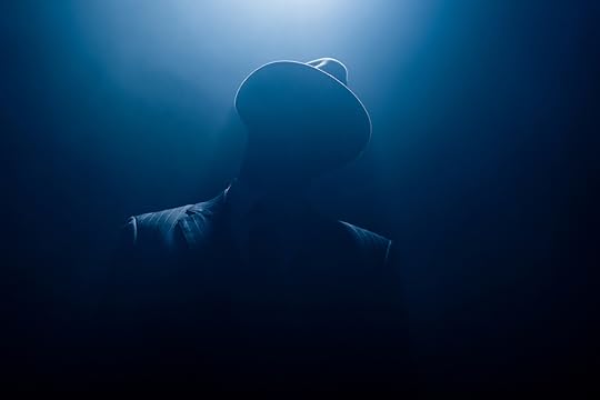 Silhouette of man in suit and hat