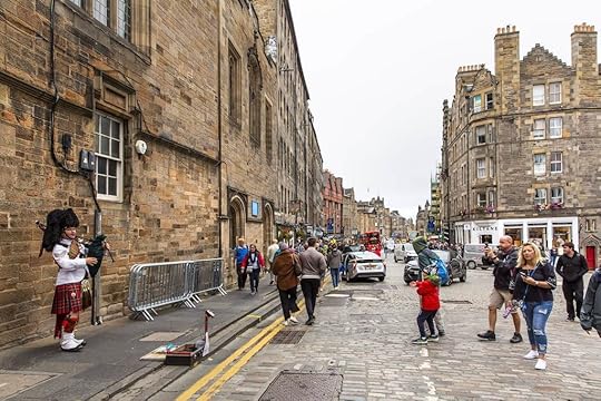 Bagpiper performs on the street of the Royal Mile.