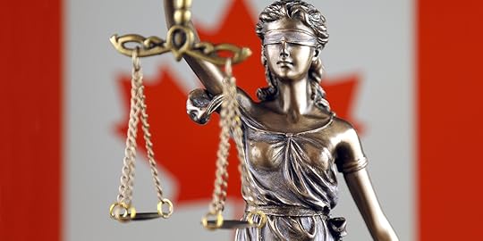 justice scales statue and Canadian flag