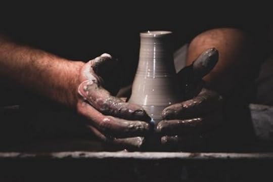 Potter throwing at the pottery wheel