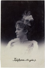 Black and white image of the circus horsewoman Zephora Furr from MUCEM. Nineteenth-century photograph of a white woman with curly hair and feather hair decoration, pearl choker, and open-necked dress with white fur trim.