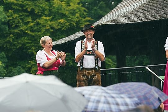people dancing in the rain at morning festival