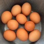brown eggs in a metal basket.