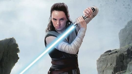 Dais Ridley's Rey holds her blue lightsaber facing downward. Rey will return to Star Wars in one of three new movies.