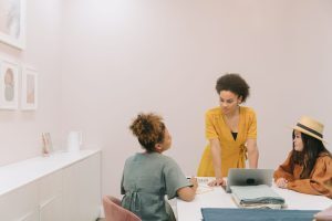 3 women sitting at a computer