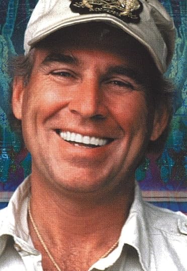 Color portrait close up of a smiling Jimmy Buffett, wearing a baseball cap