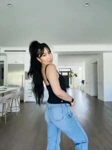 Cassey wearing the Black Corset Cami corset tank top with jeans to dress dress up the product 