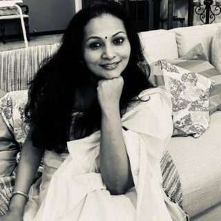 Smitha Vinwnath sitting on a couch