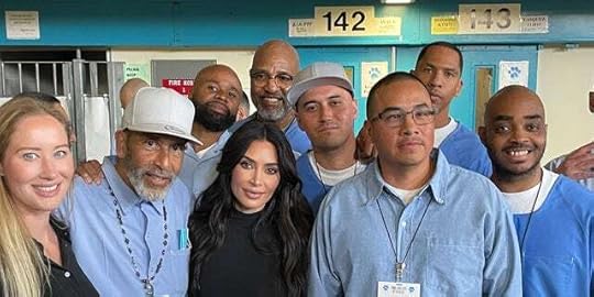 Kim Kardashian, center, poses with several of the inmates her group encountered at a prison in Lancaster, Calif., on Monday.