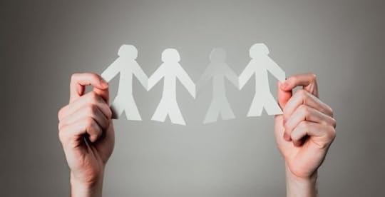 Person holding up a paper chain of people to represent supportive relationships