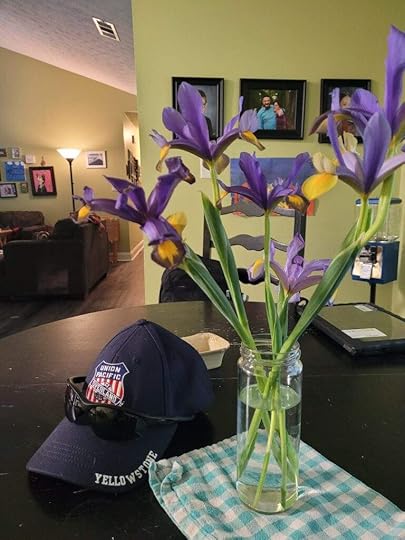 Purple Iris flowers in a mason jar on a dining room table - photo by Steph Calvert Art