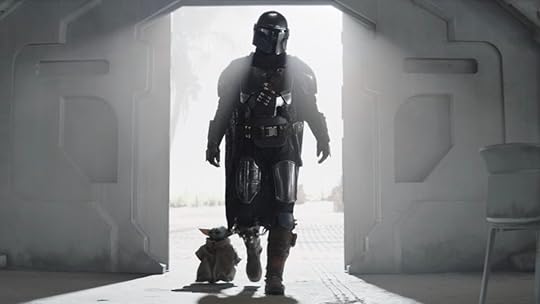 Din Djarin and Grogu walk through a sun-streaked door on The Mandalorian