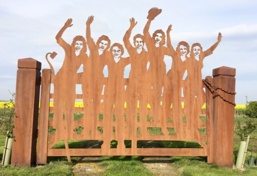 The Land Girls Gate in Clochan, colourful farmland beyond