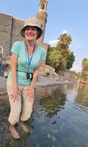 WOman wading in sea of galilee