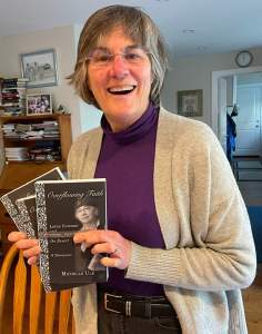 Michelle Ule holding a copy of Overflowing Faith