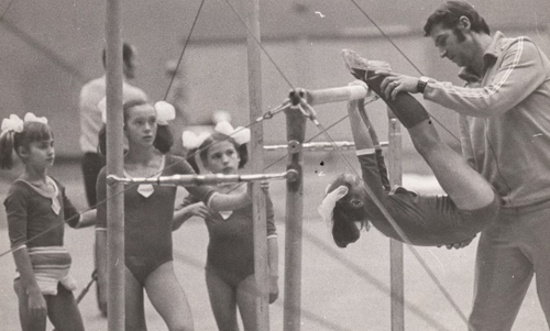 black ad white photo of Karolyi training young gymnasts