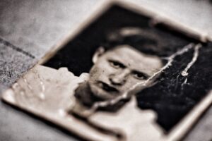 Old photograph of a serious looking man staring into the camera