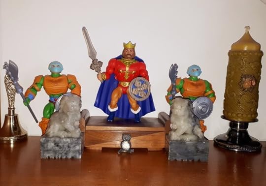 King Randor is on his throne, flanked by two guards