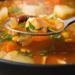 spoon of chicken taco soup over the bowl of soup.