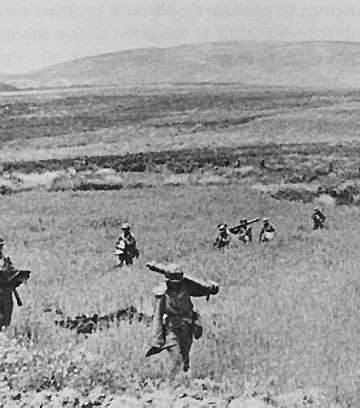 US troops advancing near Hill 609 in Tunisia, 28 April 1943 (US Army Center of Military History)